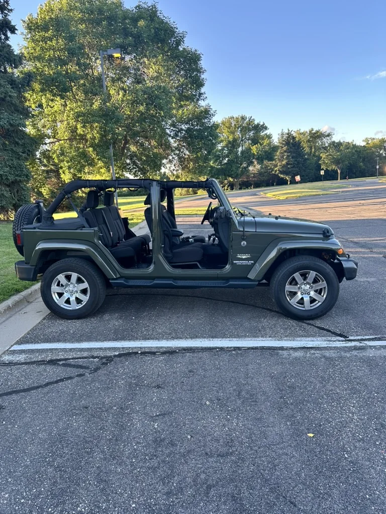 Jake's green four-door 2015 Jeep Wrangler JKU with the doors removed